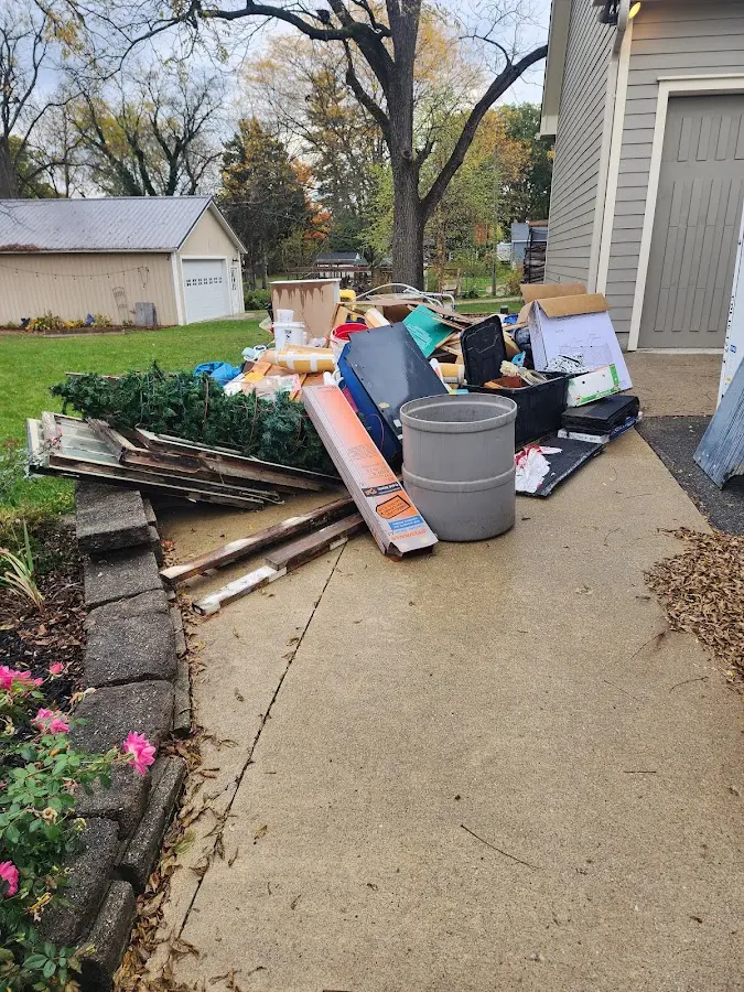 Dumpster being loaded with debris for Commercial Dumpster Rental in Sterling